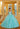 This Valentina Collection dress is available in purple, aqua, and pink.