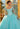 This Valentina Collection dress is available in purple, aqua, and pink.