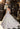 This Vizcaya Collection dress is available in champagne and purple.