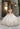 This Vizcaya Collection dress is available in champagne, purple, and red.