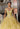 This Vizcaya Collection dress is available in purple, pink, and yellow.