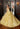 This Vizcaya Collection dress is available in purple, pink, and yellow.